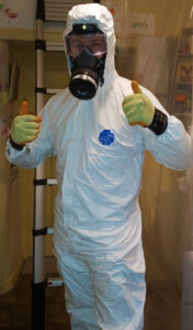 Pest controller in boiler suit and mask